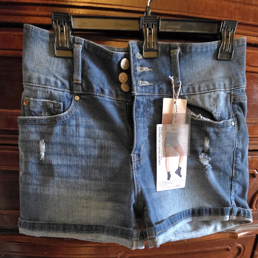 Blue Jean Shorts by Enjean, size M with destructed and Lycra fibers details.
